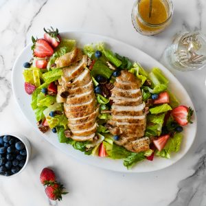 salad with berries, pecans, and pan seared chicken