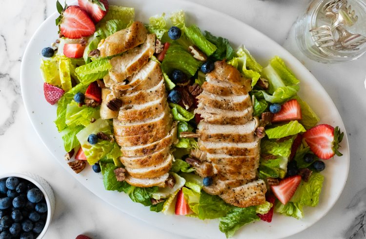 salad with berries, pecans, and pan seared chicken